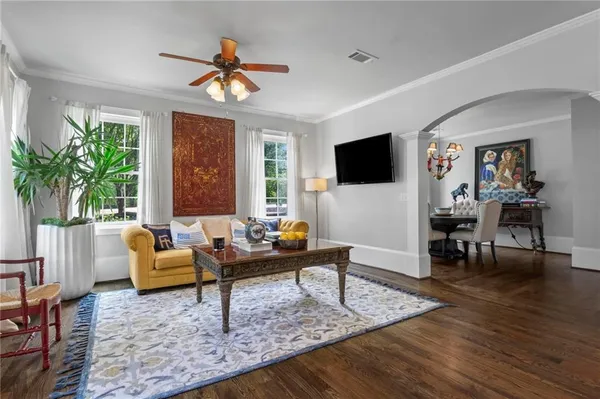 a living room with furniture and a potted plant
