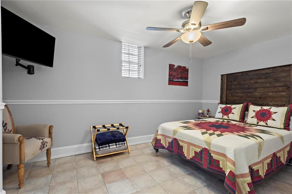 285 Old Hornage Road Ball Ground, GA 30107 - Photo 57 of 64 a bedroom with a bed and a flat screen tv