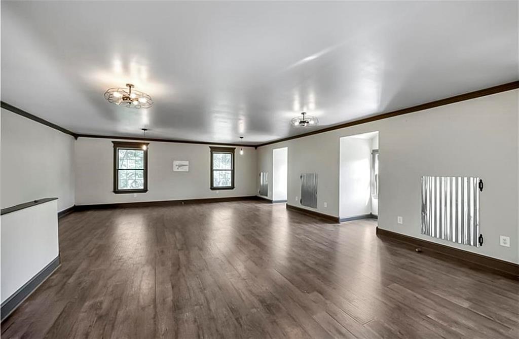 285 Old Hornage Road Ball Ground, GA 30107 - Photo 58 of 64 a view of a livingroom with hardwood floor and a ceiling fan