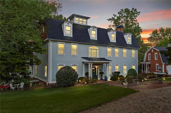 front view of a brick house with a yard