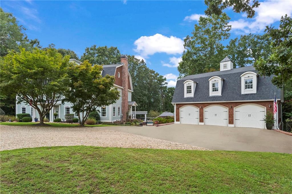 285 Old Hornage Road Ball Ground, GA 30107 - Photo 7 of 64 a front view of a house with a yard and trees