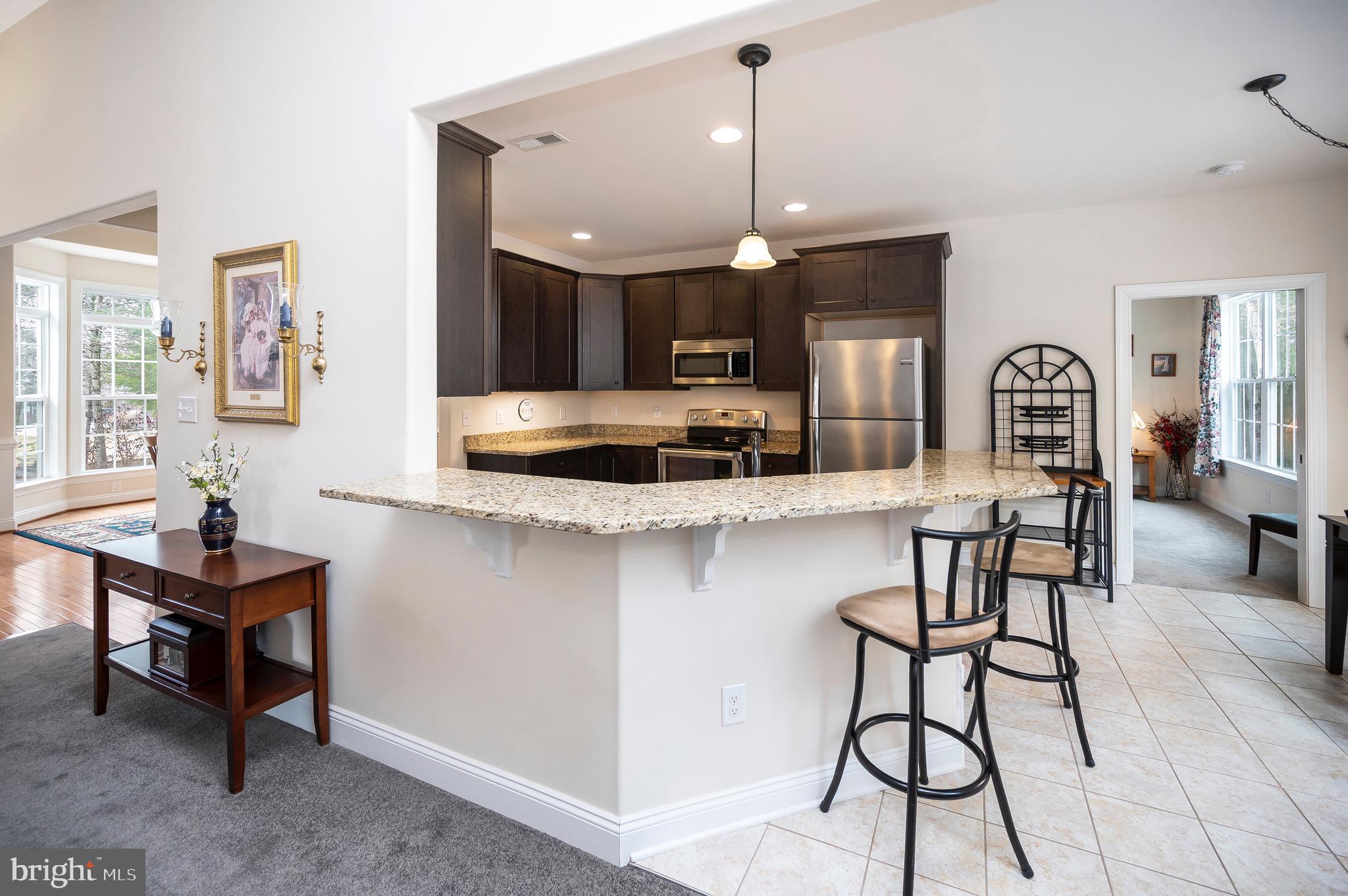 23145 Walker's Branch Road Unionville, VA 22567 - Photo 12 of 48 a kitchen with stainless steel appliances kitchen island granite countertop a stove a sink and a refrigerator