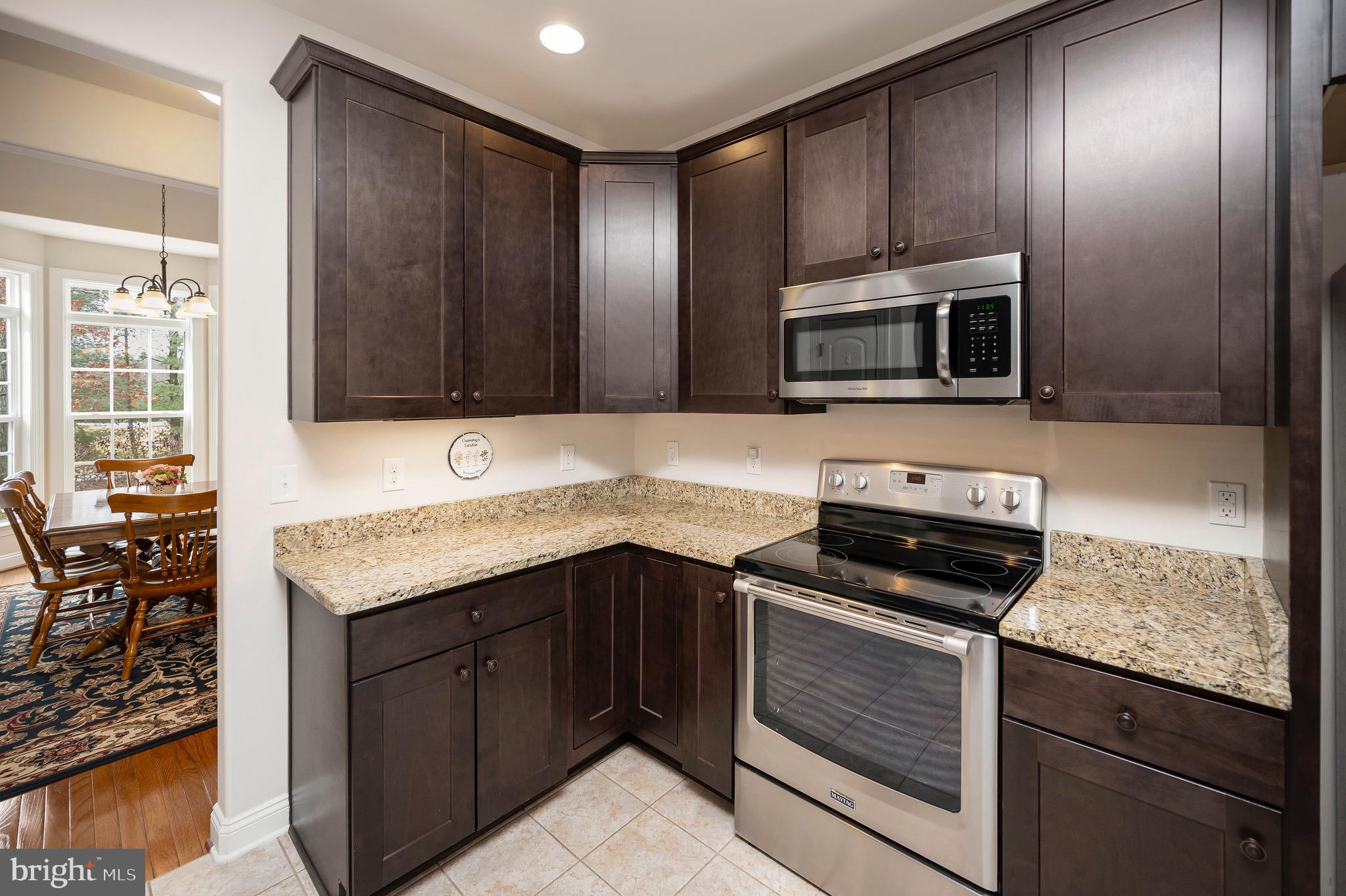 23145 Walker's Branch Road Unionville, VA 22567 - Photo 15 of 48 a kitchen with granite countertop wooden cabinets and stainless steel appliances