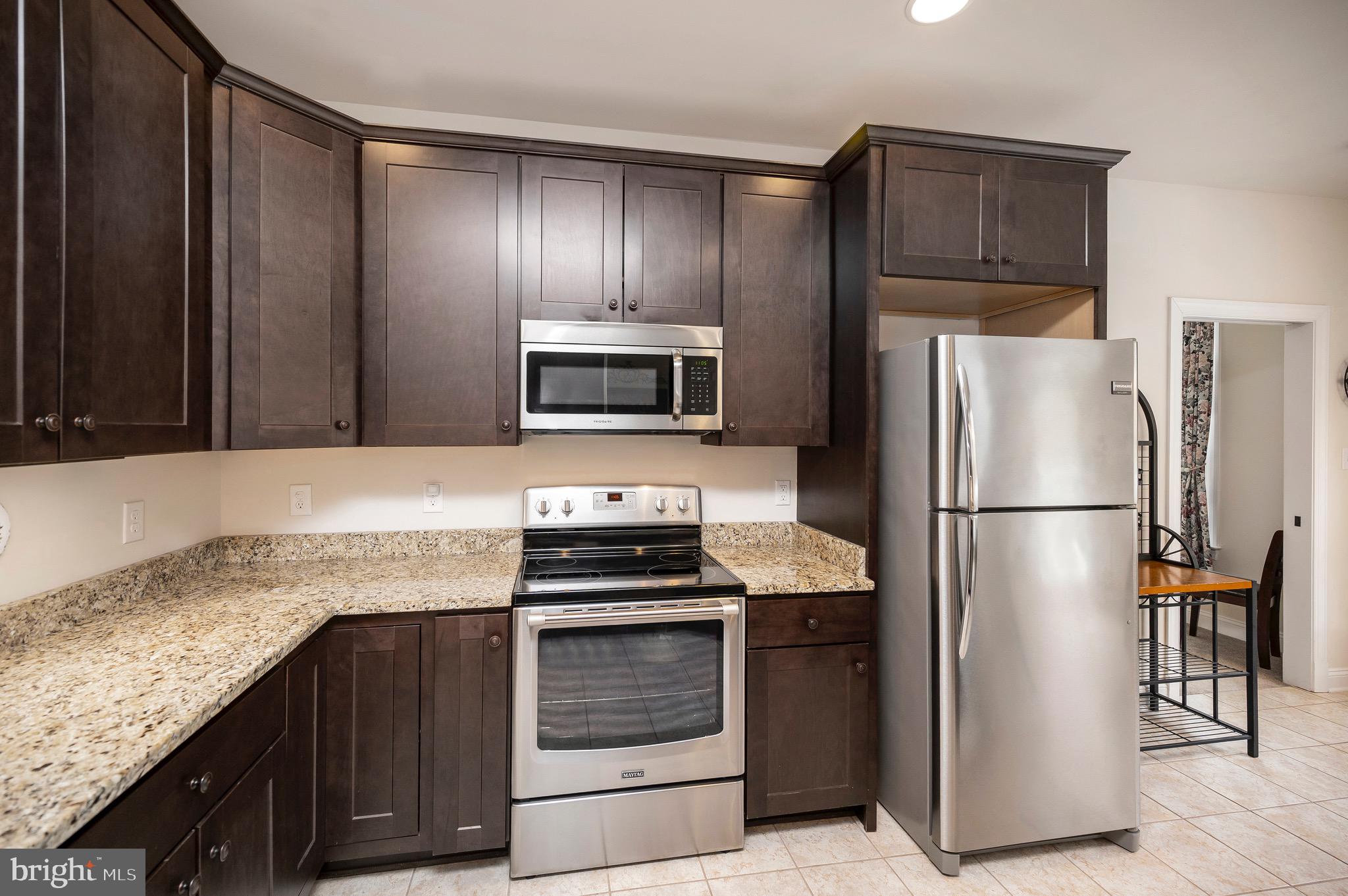 23145 Walker's Branch Road Unionville, VA 22567 - Photo 16 of 48 a kitchen with granite countertop stainless steel appliances and refrigerator