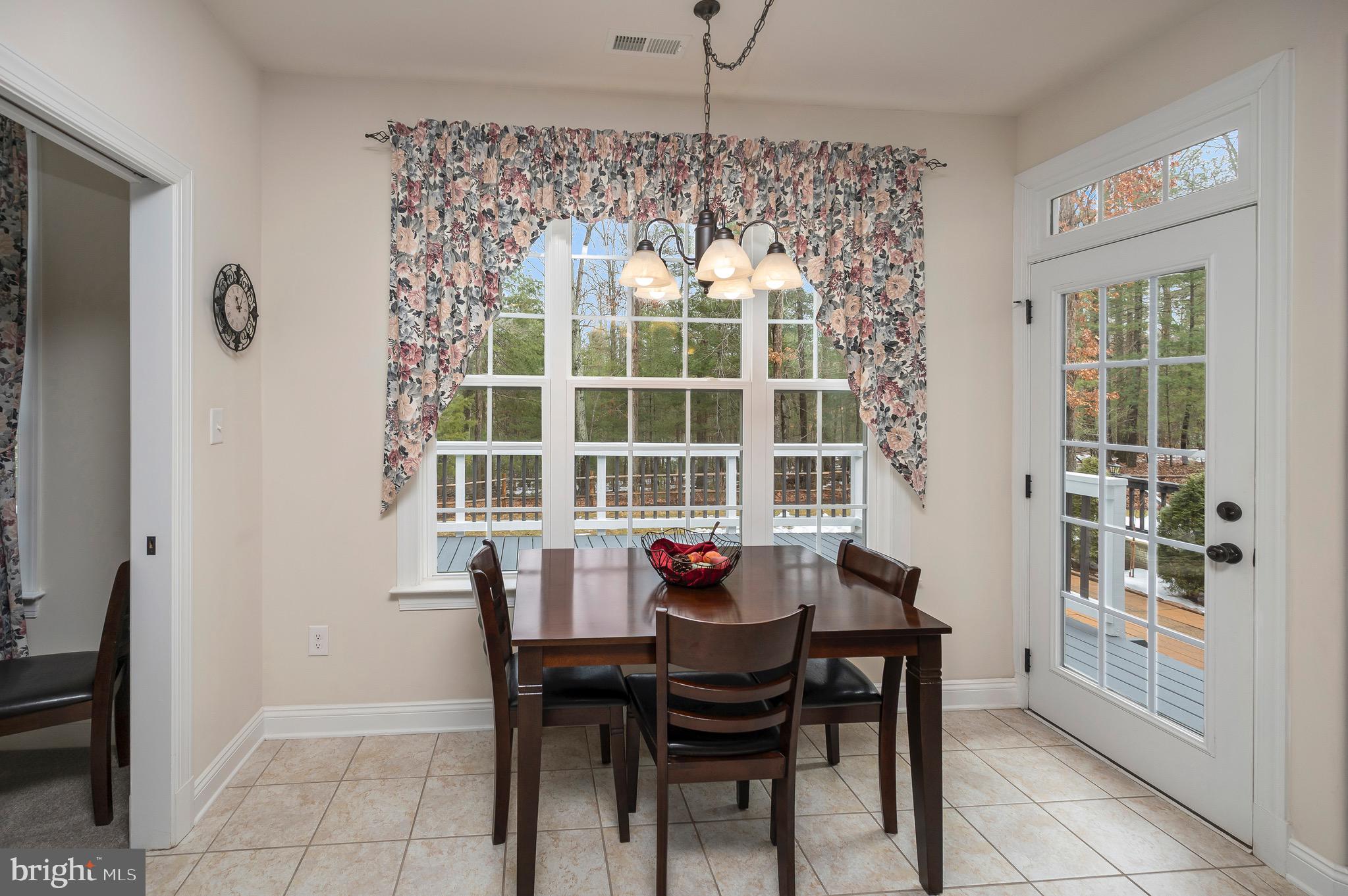23145 Walker's Branch Road Unionville, VA 22567 - Photo 19 of 48 a view of a dining room with a table and chairs
