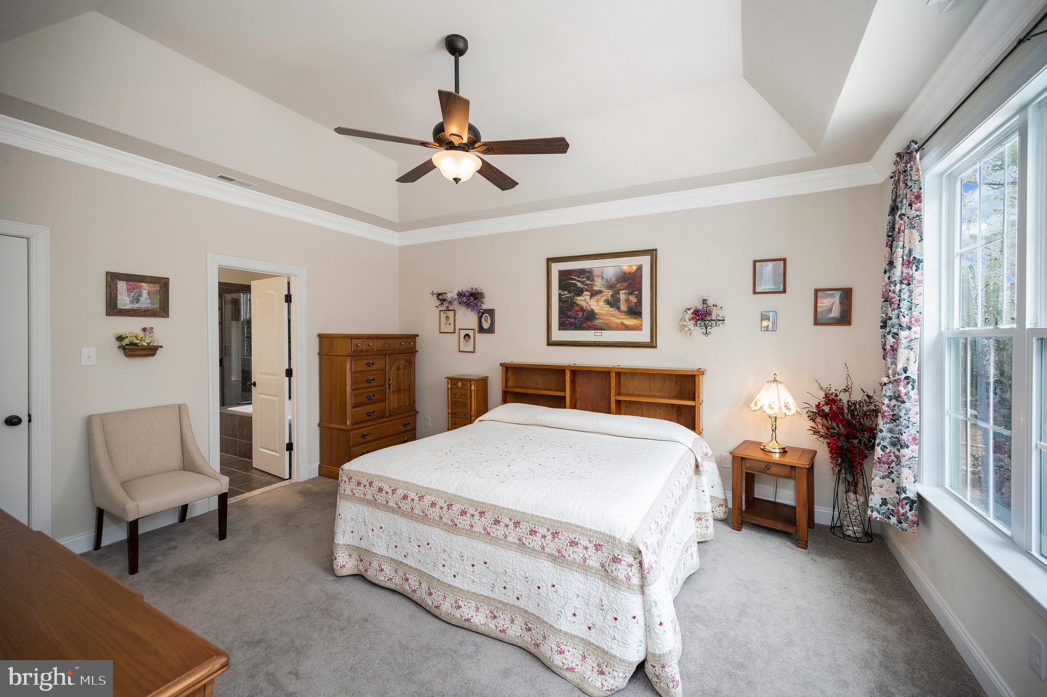 23145 Walker's Branch Road Unionville, VA 22567 - Photo 23 of 48 a spacious bedroom with a bed a couch and a window