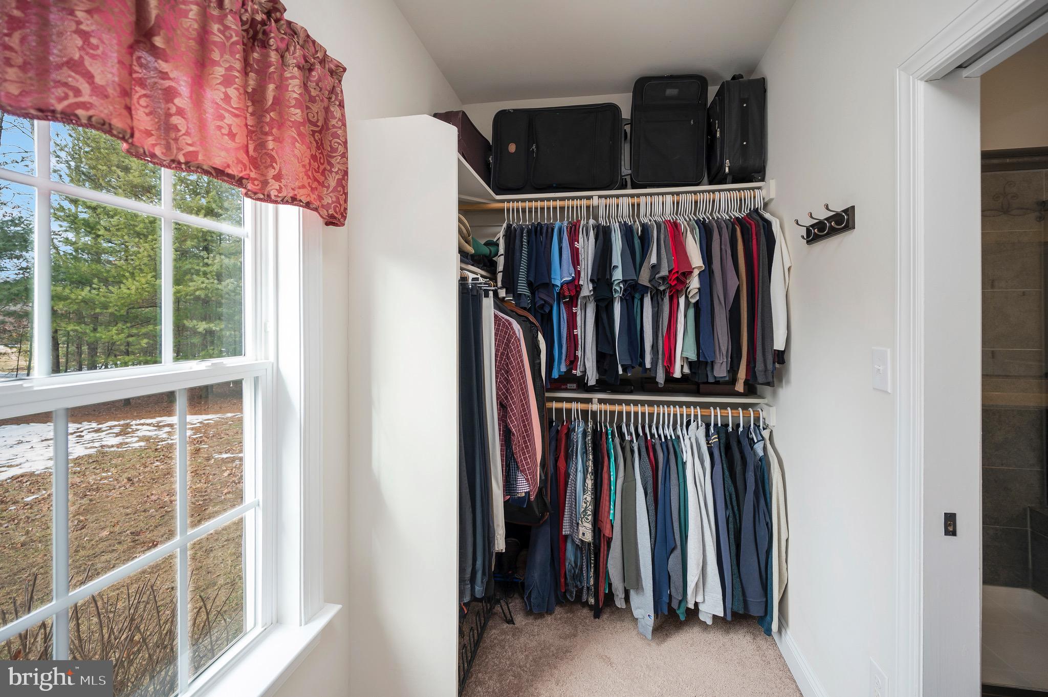 23145 Walker's Branch Road Unionville, VA 22567 - Photo 28 of 48 a view of walk in closet with clothes