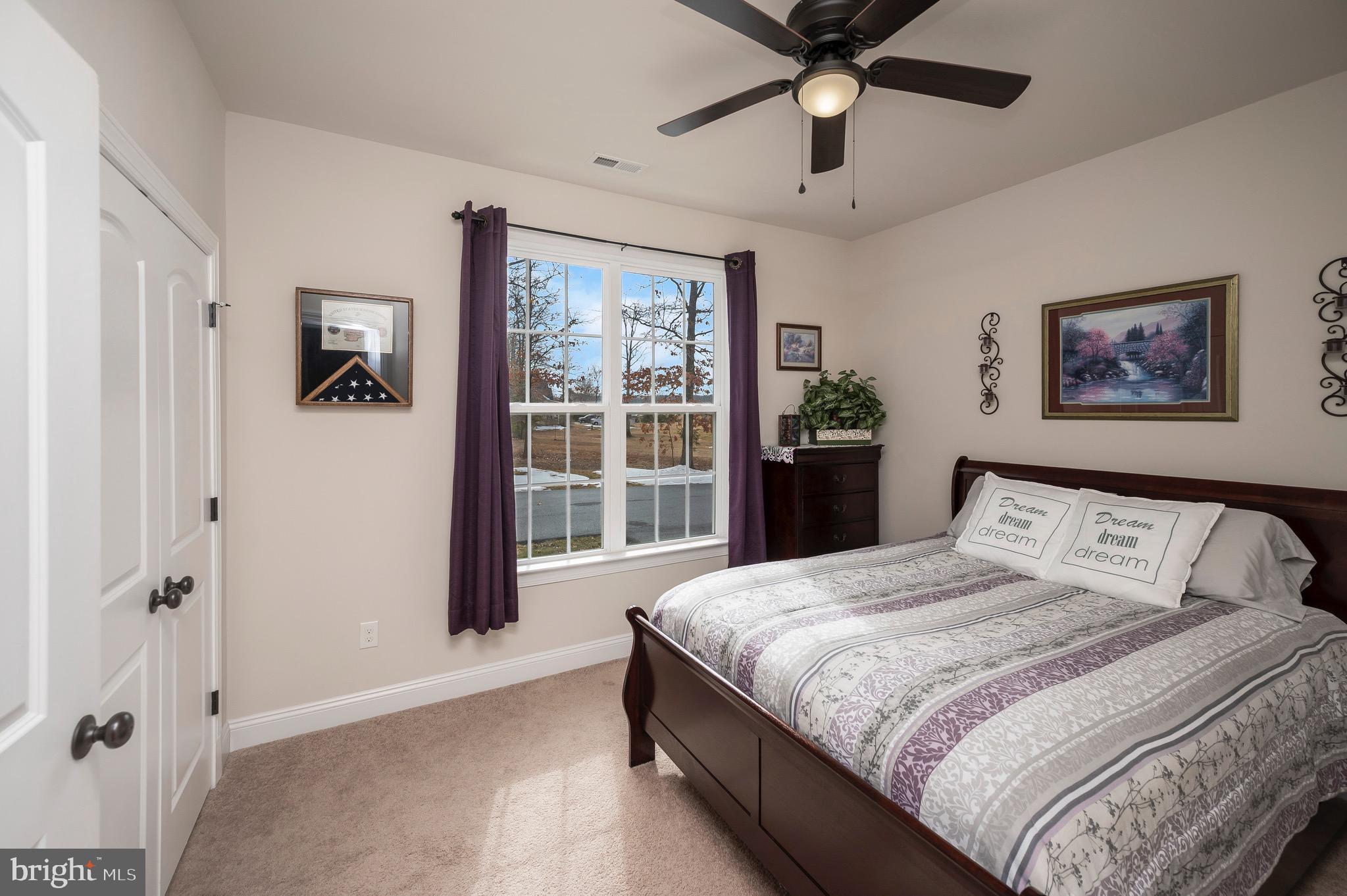 23145 Walker's Branch Road Unionville, VA 22567 - Photo 30 of 48 a bedroom with a large bed and a chandelier