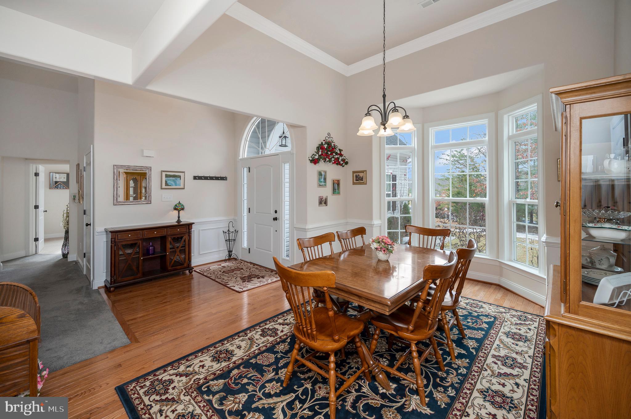23145 Walker's Branch Road Unionville, VA 22567 - Photo 6 of 48 a living room with furniture a dining table and a chandelier