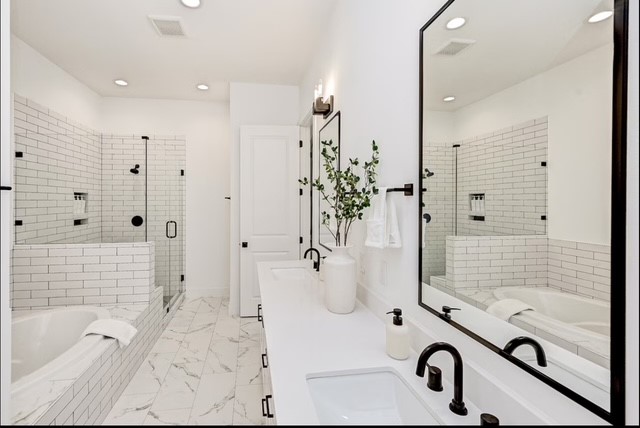 a bathroom with a tub mirror and shower