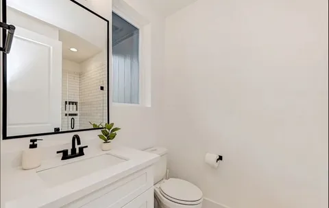 a bathroom with a sink toilet and vanity