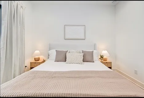 a bedroom with a bed and a lamp