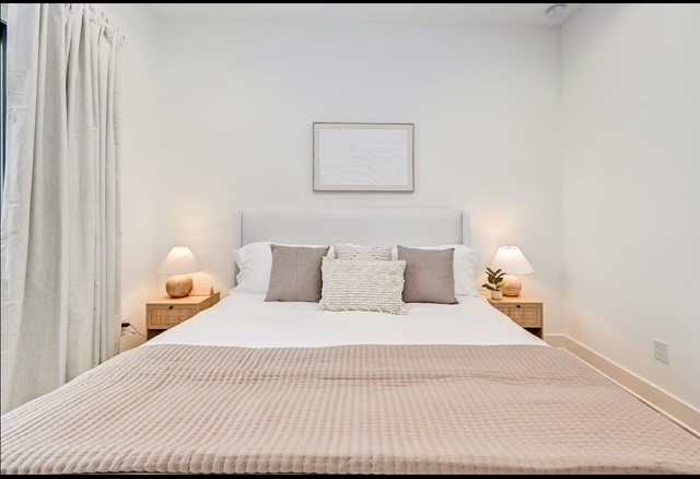 5910 Val Verde Street Houston, TX 77057 - Photo 14 of 21 a bedroom with a bed and a lamp