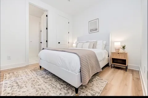 a bedroom with a bed and a dresser