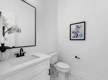 a bathroom with a sink a toilet and mirror