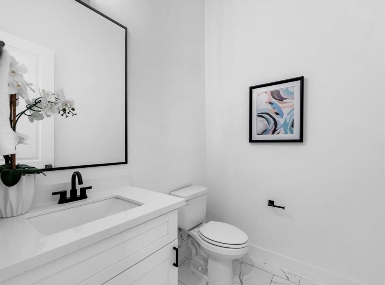 5910 Val Verde Street Houston, TX 77057 - Photo 17 of 21 a bathroom with a sink a toilet and mirror