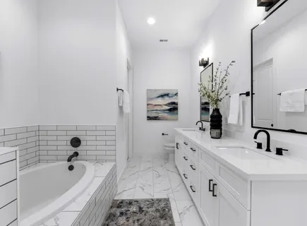 a bathroom with a tub sink and mirror