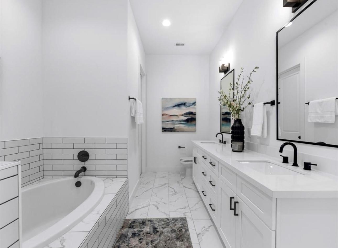 5910 Val Verde Street Houston, TX 77057 - Photo 18 of 21 a bathroom with a tub sink and mirror
