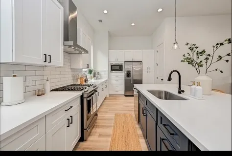 a kitchen with sink a stove and cabinets