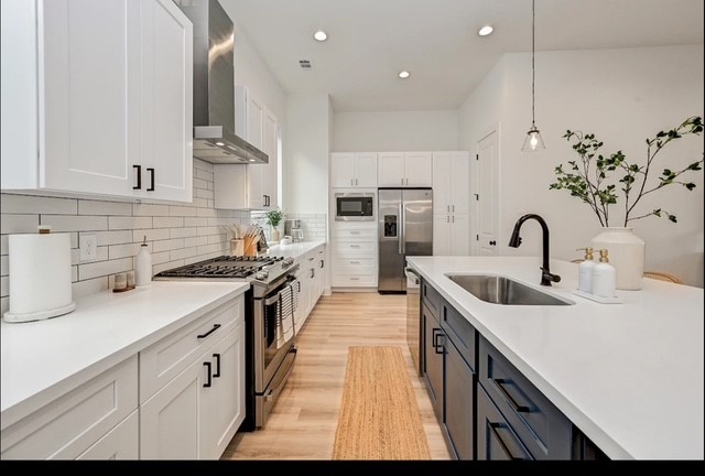 5910 Val Verde Street Houston, TX 77057 - Photo 5 of 21 a kitchen with sink a stove and cabinets