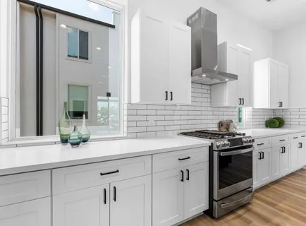 a kitchen with stainless steel appliances white cabinets and a stove