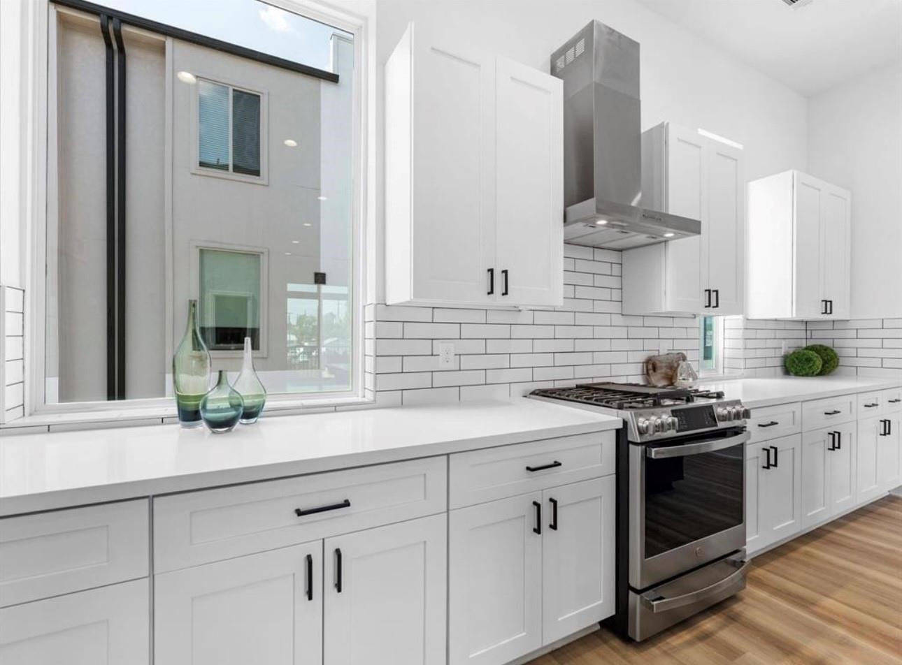 5910 Val Verde Street Houston, TX 77057 - Photo 8 of 21 a kitchen with stainless steel appliances white cabinets and a stove