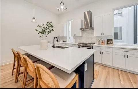 a kitchen with stainless steel appliances a sink and cabinets