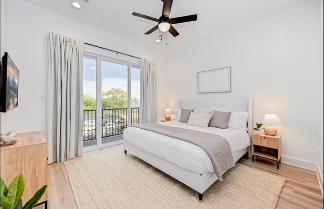 5910 Val Verde Street Houston, TX 77057 - Photo 10 of 21 a large bedroom with a bed and a flat tv screen