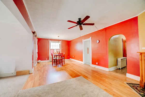 a view of an empty room with furniture and a window