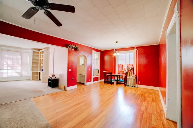 a dining room with furniture and wooden floor