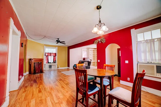 a large kitchen with a wooden floor and cabinets