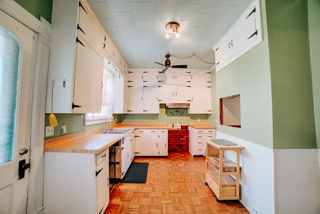 a view of kitchen with stainless steel appliances granite countertop a refrigerator and a sink