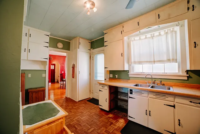 a view of kitchen with furniture and refrigerator