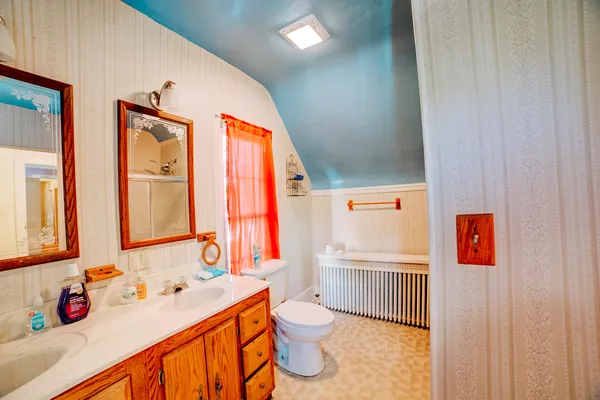 a bedroom with a bed and a mirror