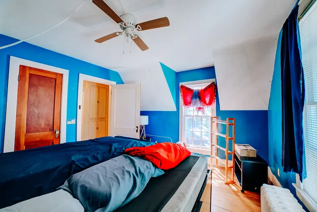 a bedroom with a bed and a chandelier