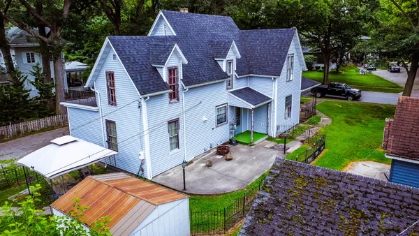 an aerial view of a house with garden space and street view