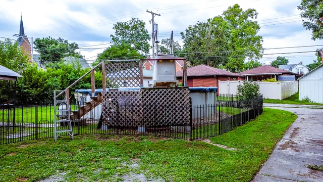 a front view of a house with a yard table and chairs
