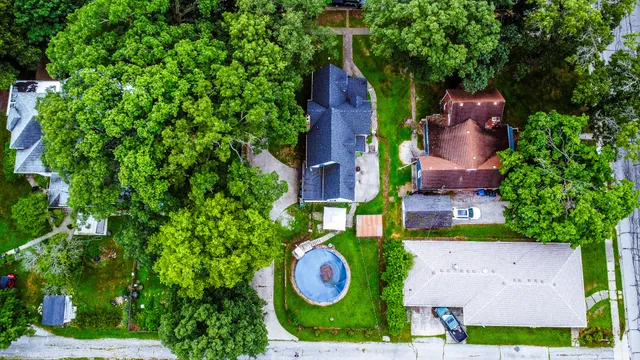 an aerial view of a house with garden space and street view