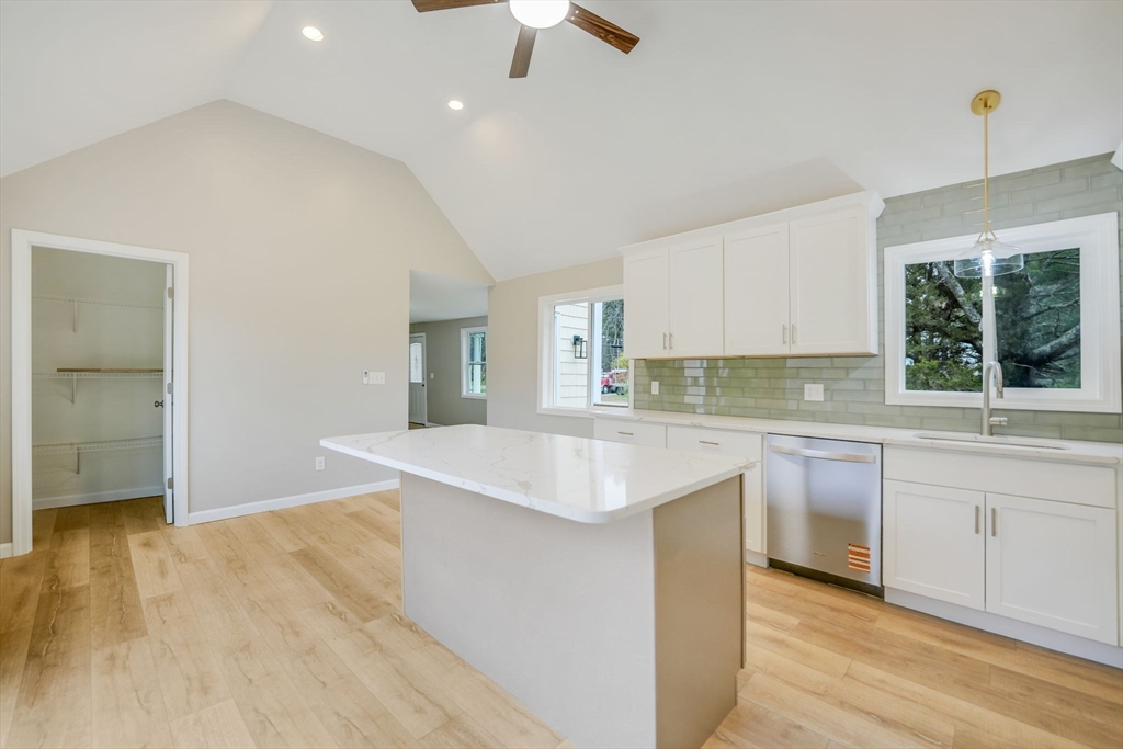 599 Quanapoag Road Dartmouth, MA 02747 - Photo 12 of 32 a kitchen with granite countertop a sink stove and cabinets