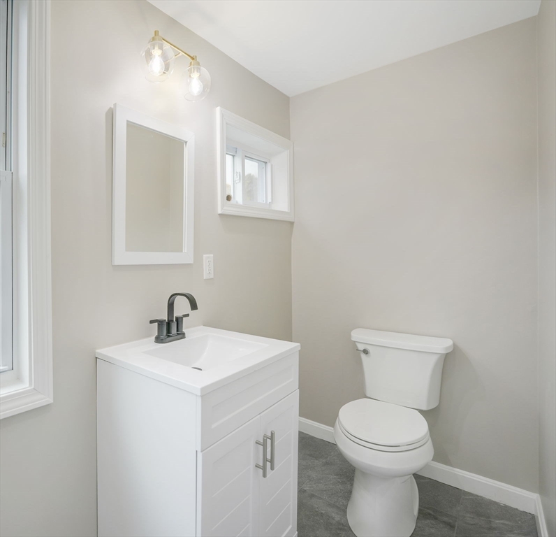 599 Quanapoag Road Dartmouth, MA 02747 - Photo 16 of 32 a white toilet sitting next to a bathroom sink