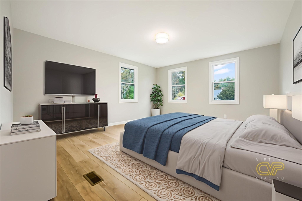 599 Quanapoag Road Dartmouth, MA 02747 - Photo 18 of 32 a bedroom with a bed and a flat screen tv