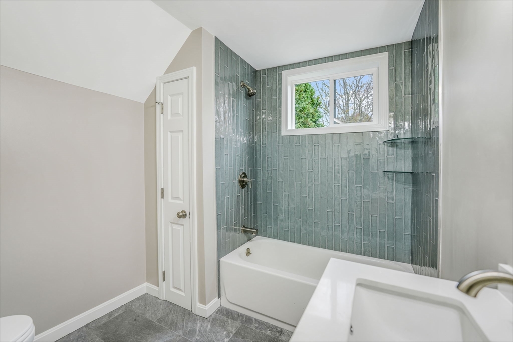 599 Quanapoag Road Dartmouth, MA 02747 - Photo 19 of 32 a bathroom with a tub a toilet and a sink