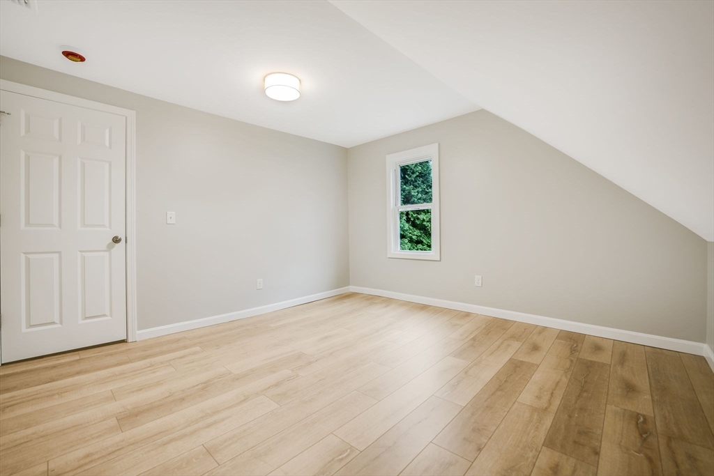 599 Quanapoag Road Dartmouth, MA 02747 - Photo 25 of 32 an empty room with wooden floor and windows