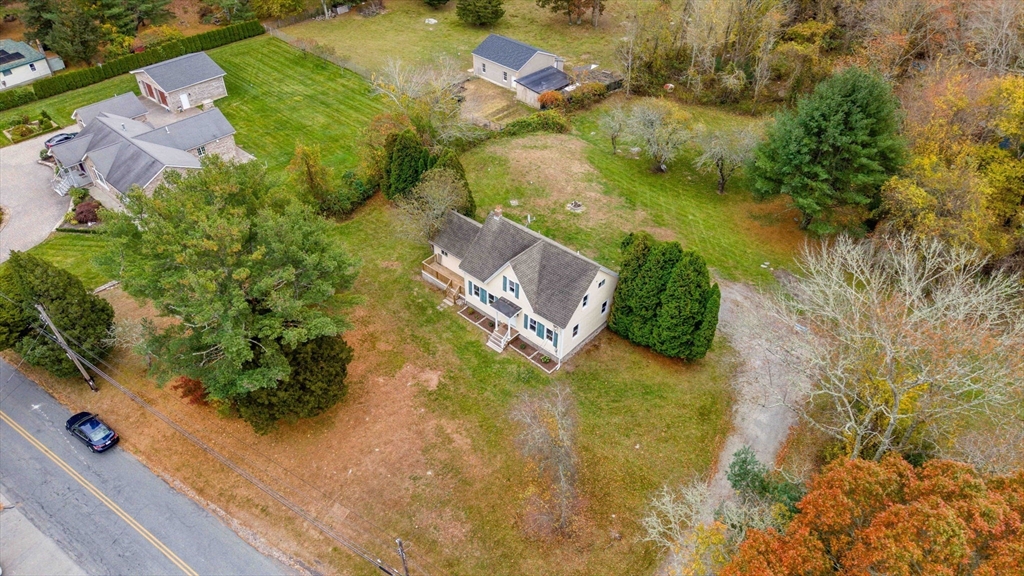 599 Quanapoag Road Dartmouth, MA 02747 - Photo 7 of 32 an aerial view of residential house with swimming pool and lawn chairs