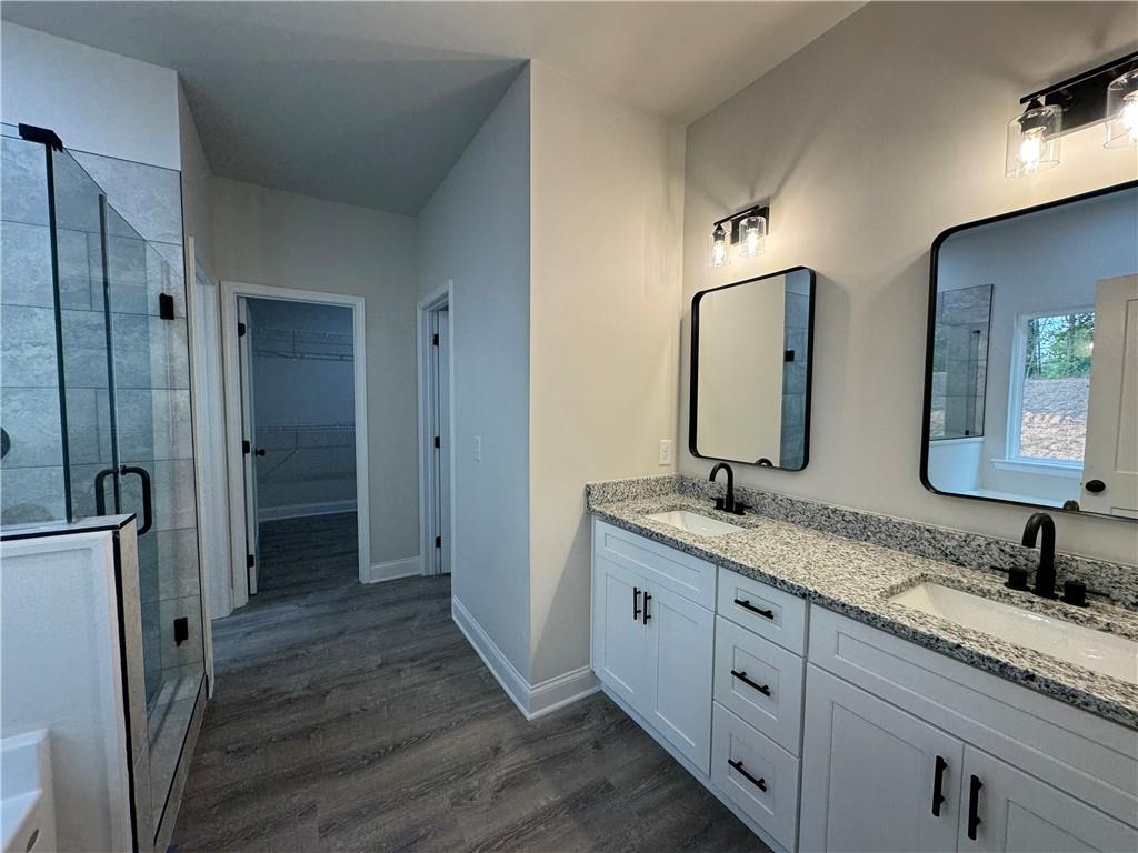 2113 North Hicks Road Toccoa, GA 30577 - Photo 12 of 28 a bathroom with double vanity sink and mirror