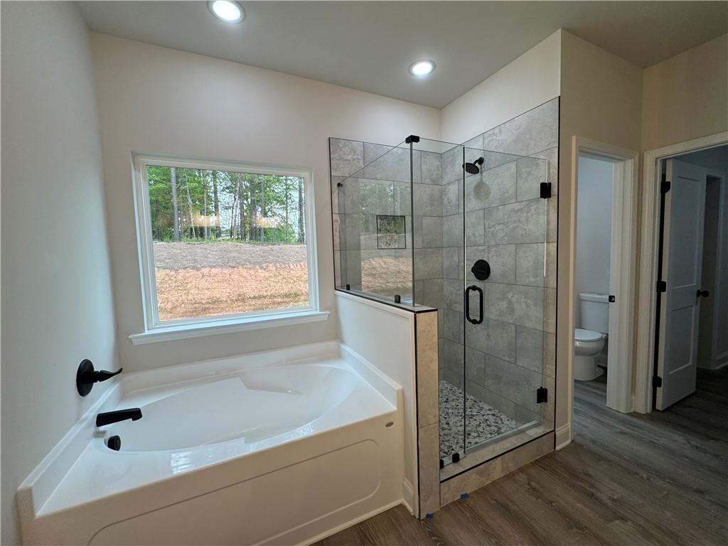 2113 North Hicks Road Toccoa, GA 30577 - Photo 13 of 28 a bathroom with a bathtub and a shower