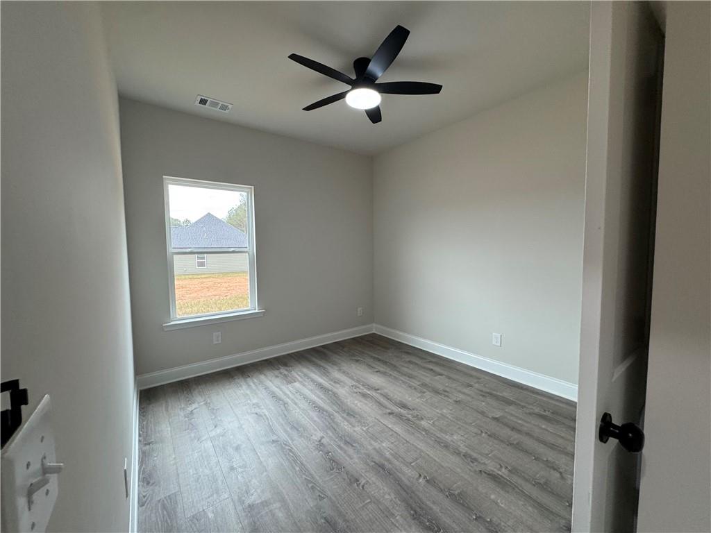 2113 North Hicks Road Toccoa, GA 30577 - Photo 22 of 28 an empty room with wooden floor and windows