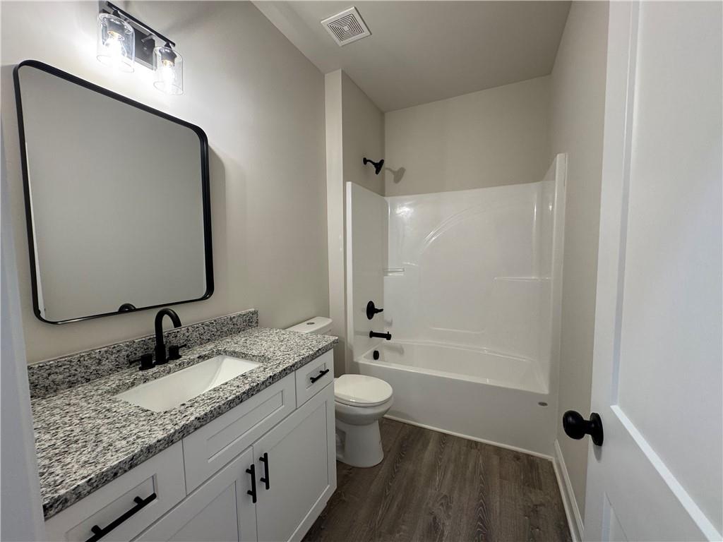 2113 North Hicks Road Toccoa, GA 30577 - Photo 23 of 28 a bathroom with a granite countertop sink toilet and shower