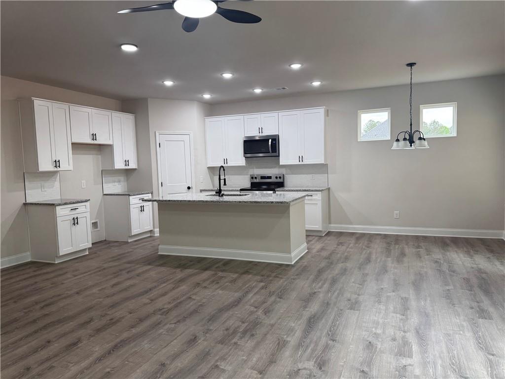 2113 North Hicks Road Toccoa, GA 30577 - Photo 6 of 28 a kitchen with kitchen island a sink stainless steel appliances and cabinets