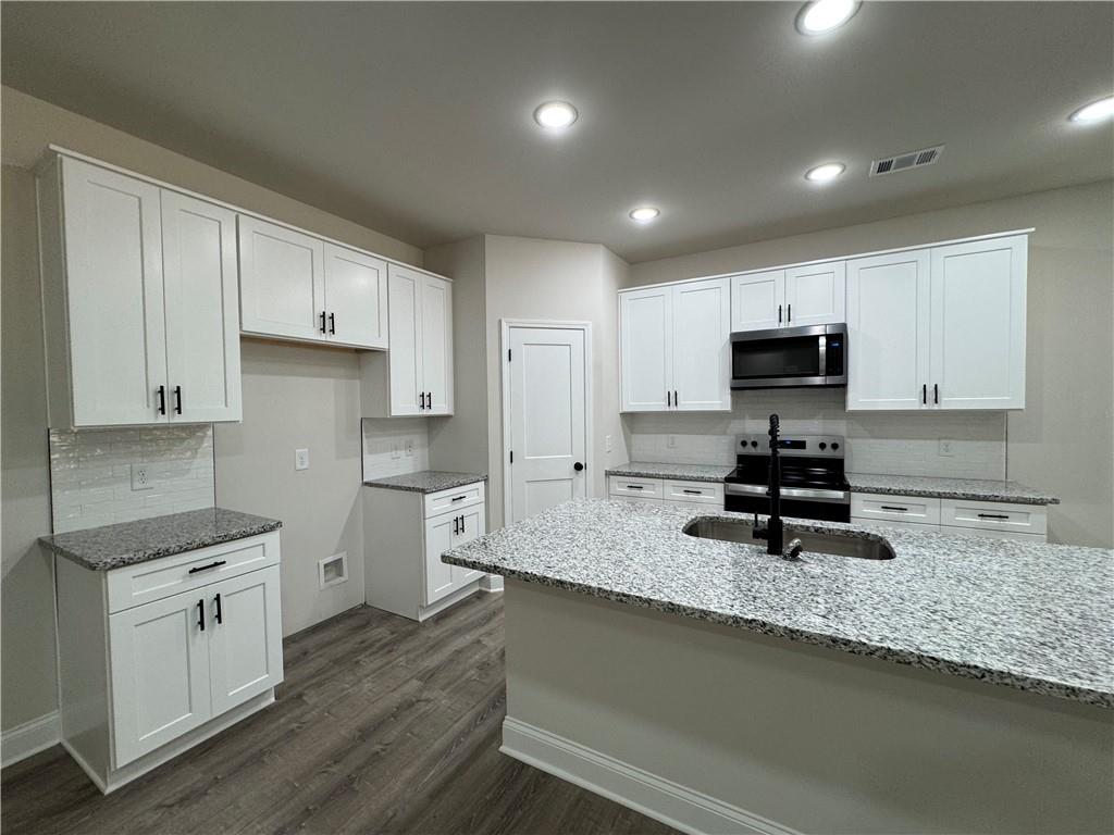 2113 North Hicks Road Toccoa, GA 30577 - Photo 9 of 28 a kitchen with sink a microwave and cabinets